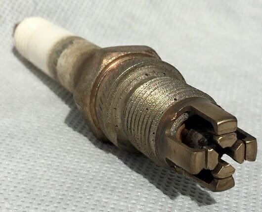 The same plug after ultrasonic recovery — electrodes and ports cleared, returned to service.