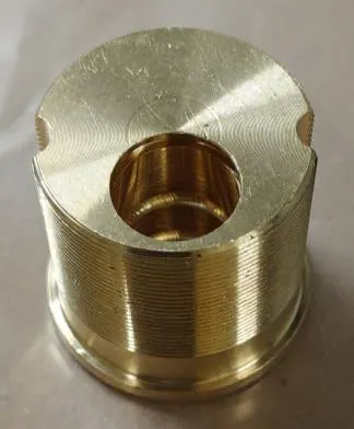 The same component after the three-stage cycle — threads clear, uniform bright finish.
