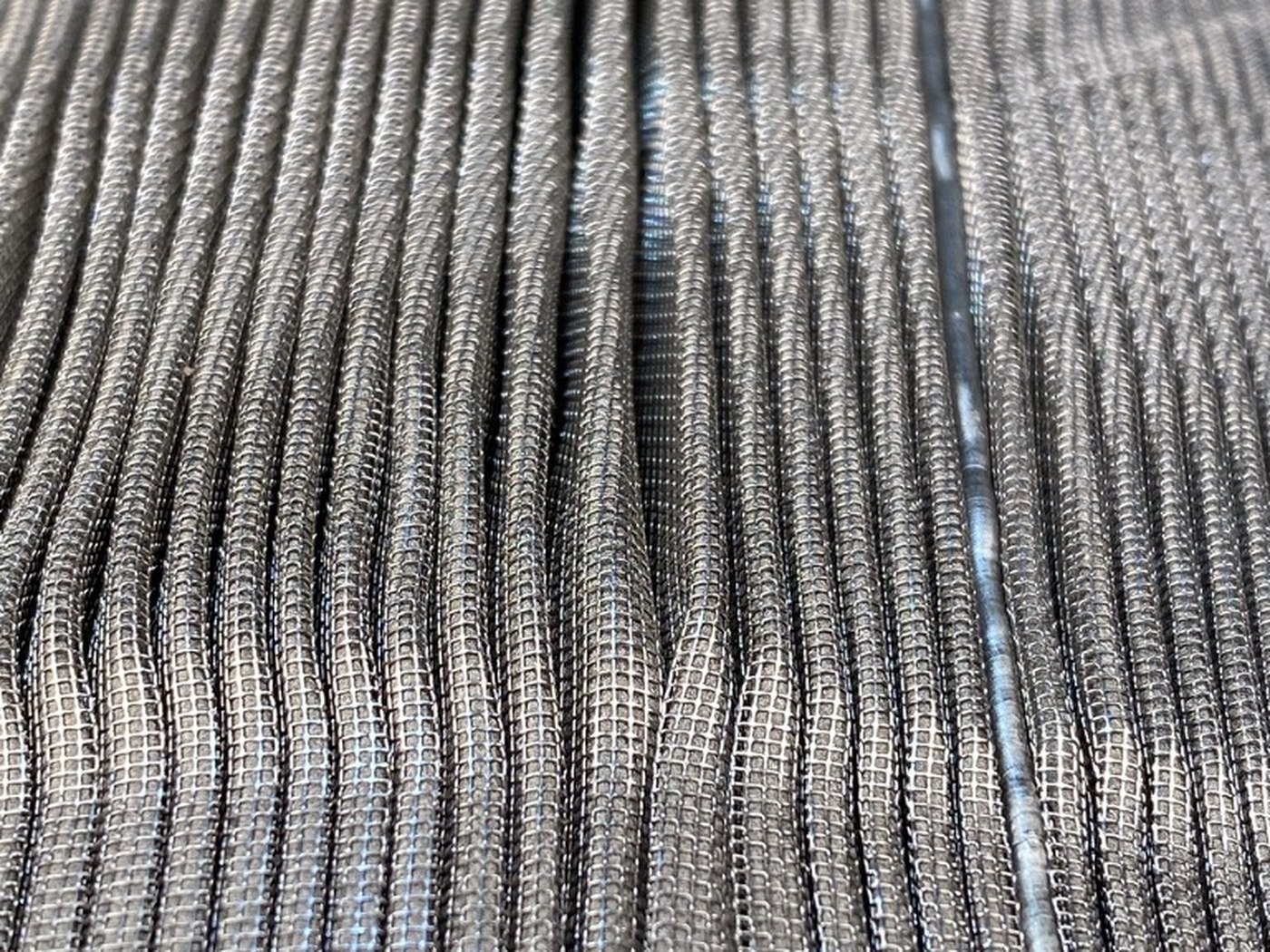 Macro of the cleaned wire cloth, individual warp and weft wires visible
