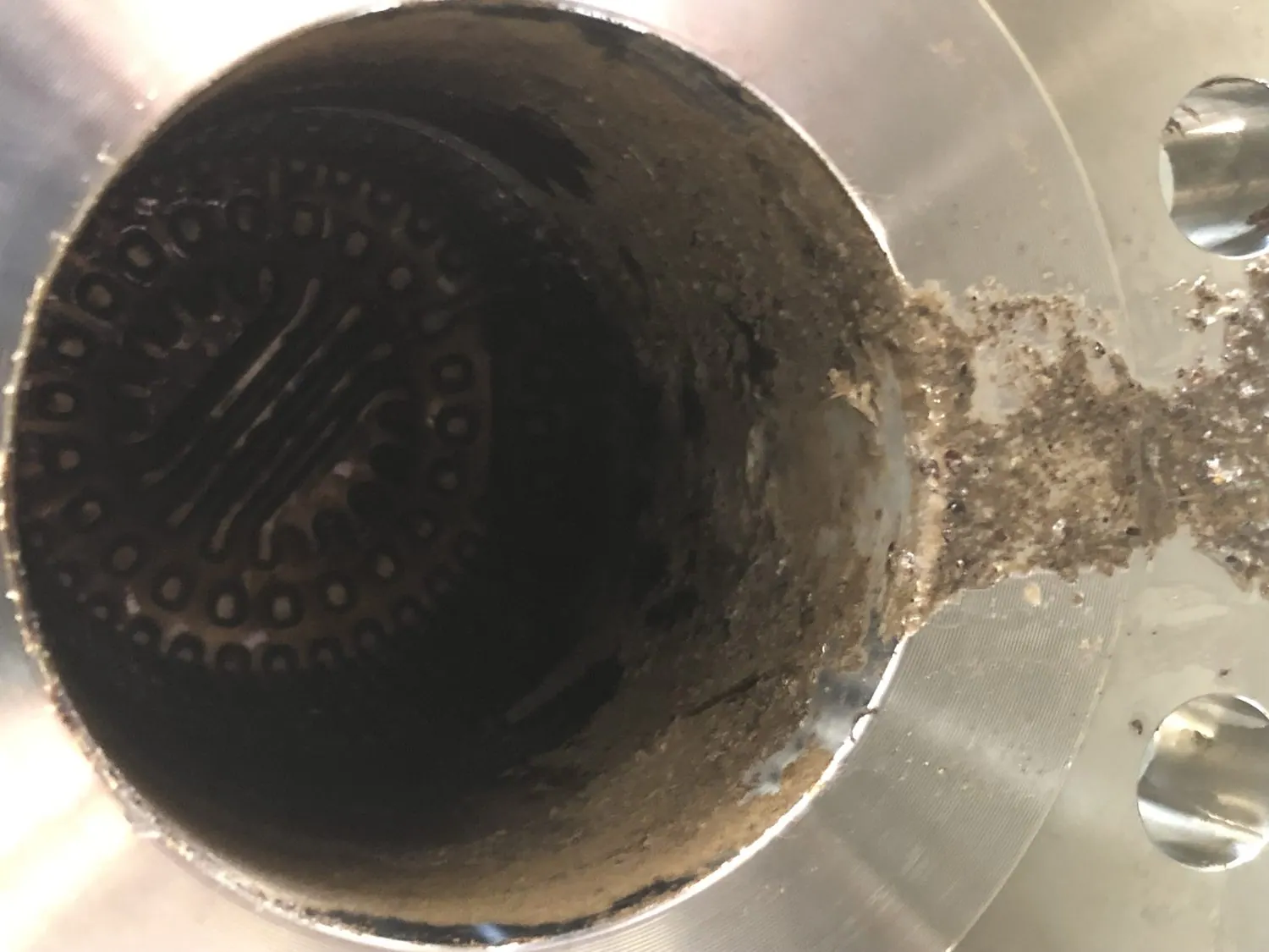 Heat exchanger tube ends at the flange face bridged with scale and oil sludge before cleaning
