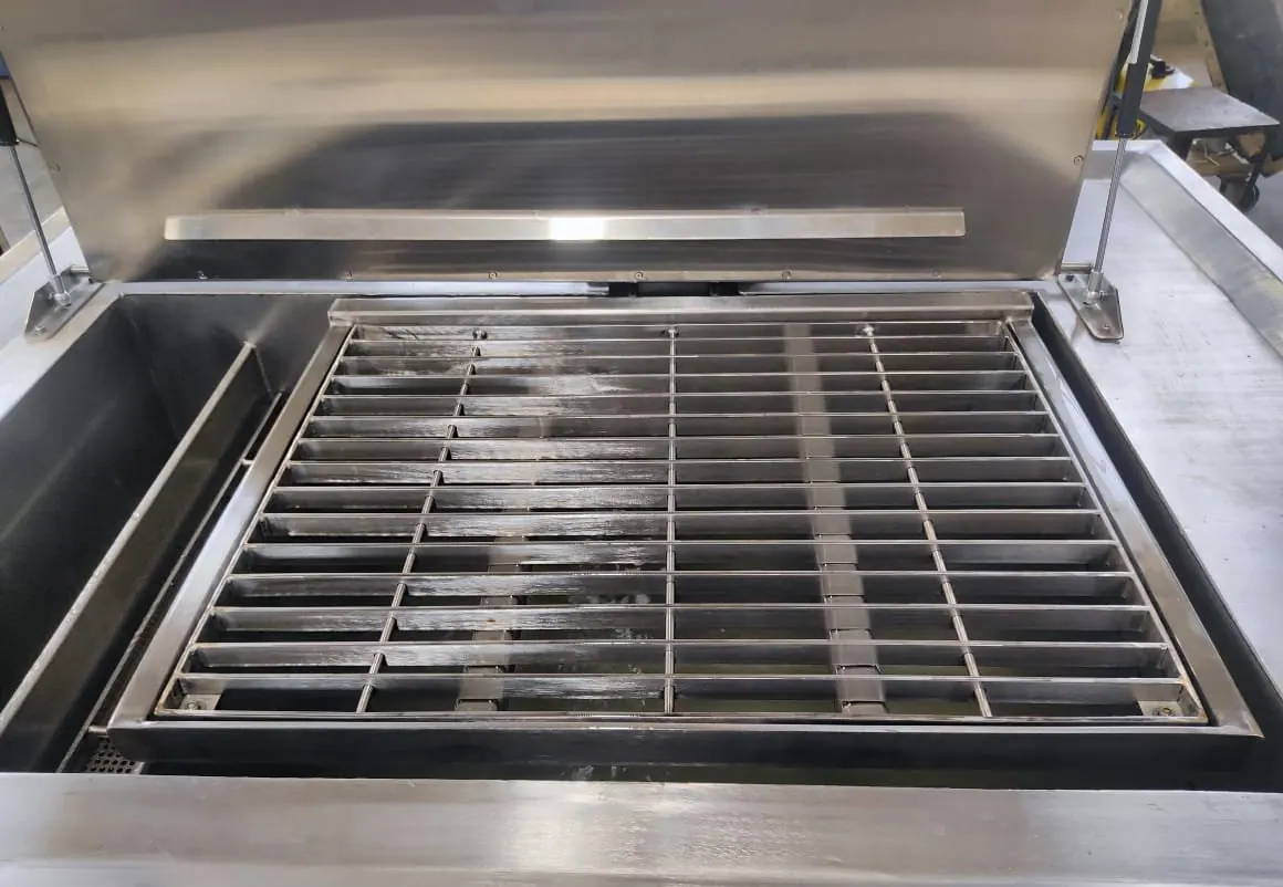 EVS 300 industrial ultrasonic cleaning tank with the lid open, showing the bath, weir and basket rails