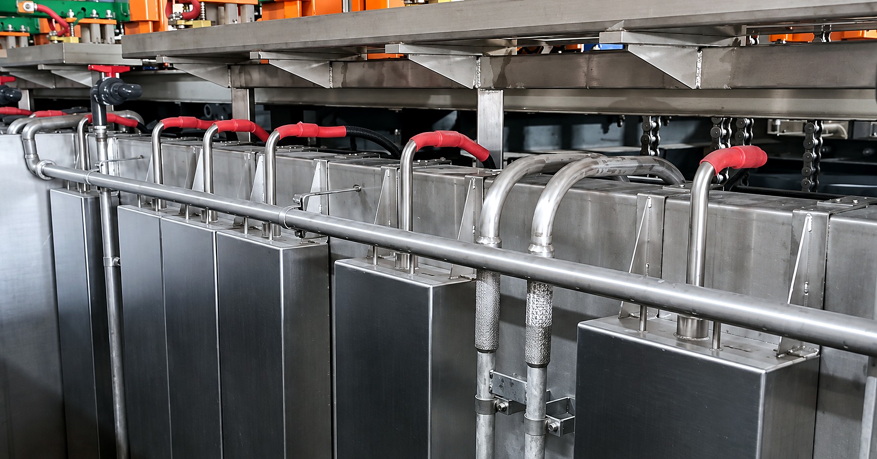 Immersible transducer boxes hung between the existing pipework and valves on a plating line