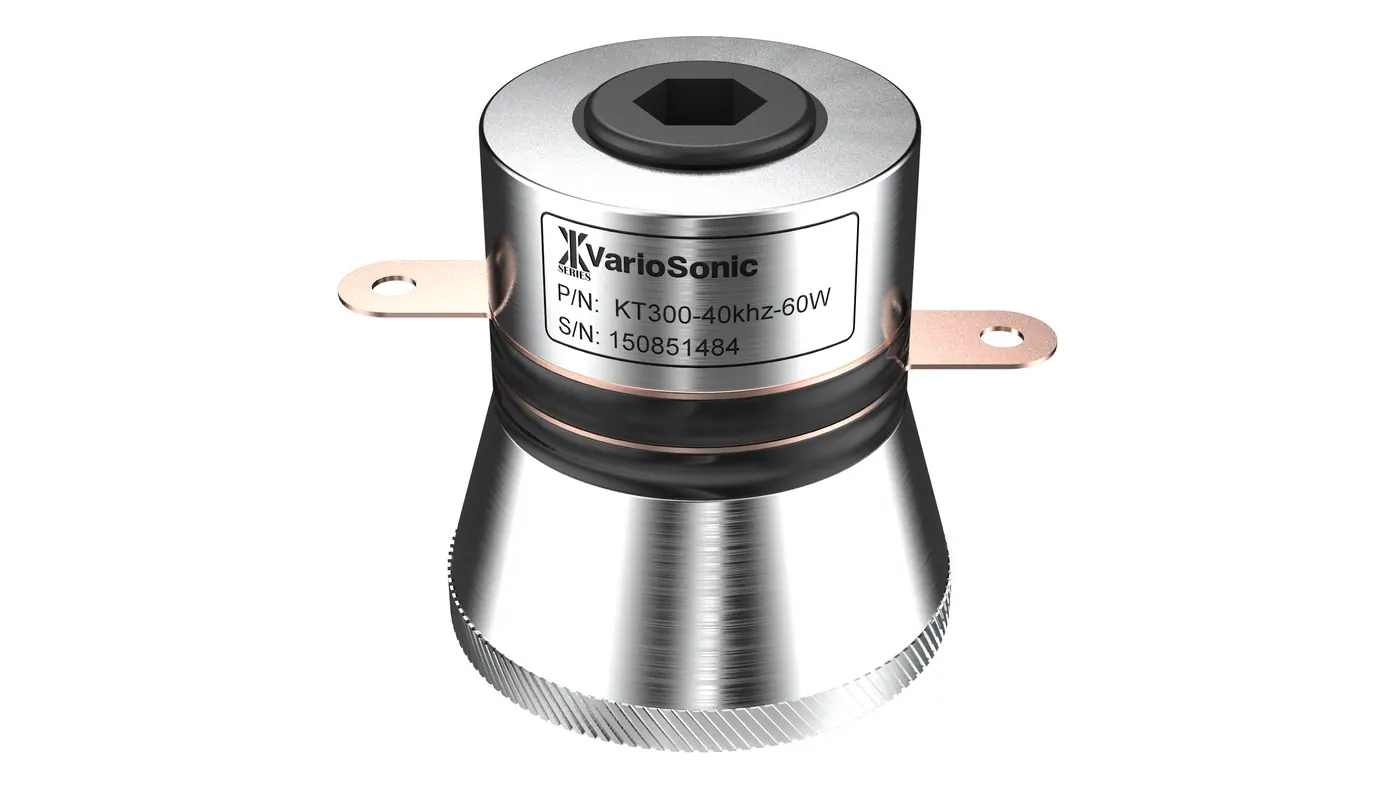 A 40 kHz bolt-clamped Langevin transducer — hex bolt through the steel back mass, ceramic stack under the black band, copper terminals, aluminium horn