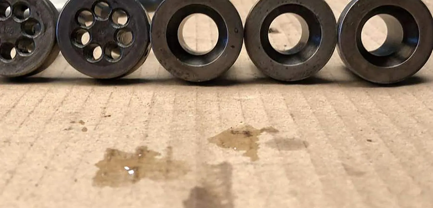 A row of food extrusion dies part-way through a documented cleaning trial in the Misonics laboratory