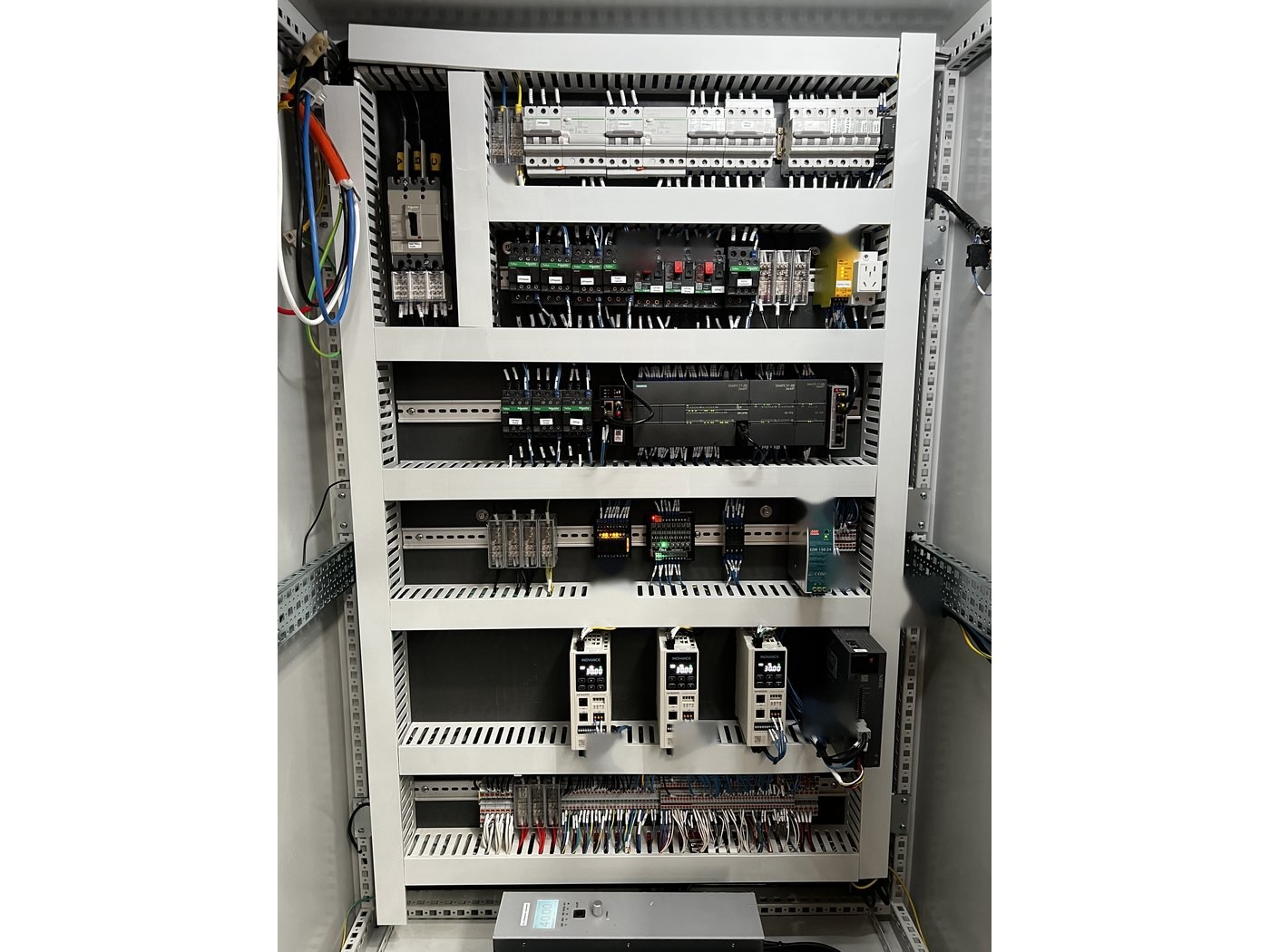 Control cabinet interior of a Misonics Sono L-130 — breakers, contactors and I/O on DIN rail