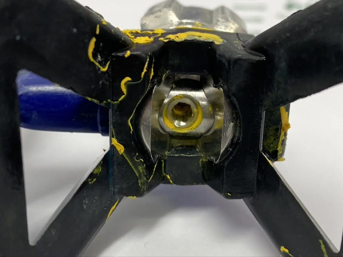 Airless tip and guard — before and after ultrasonic cleaning — as received