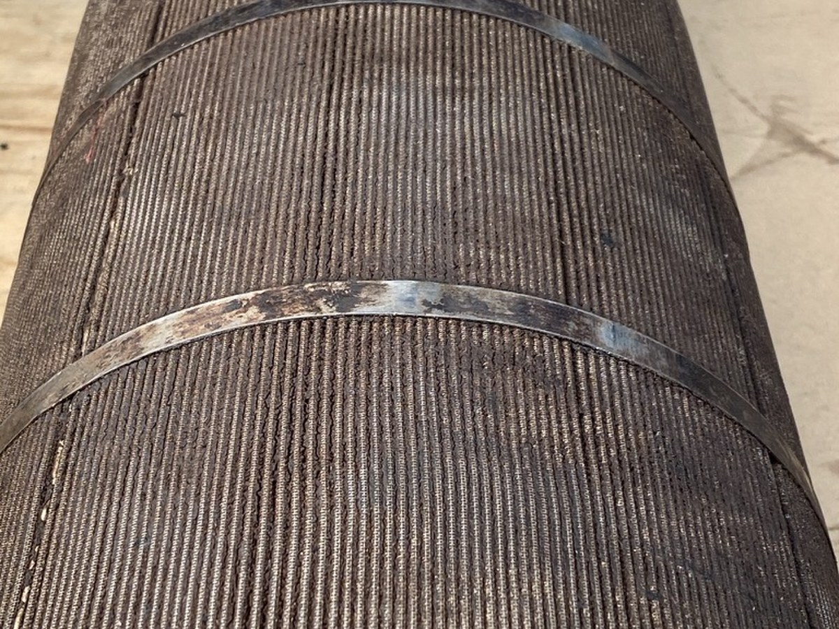 Pleated stainless mesh filter element blinded with carbonised residue, the weave completely closed