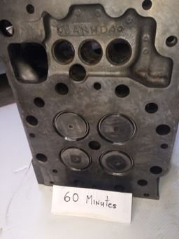 Cat 3516 cylinder head combustion face before and after ultrasonic cleaning — after the cycle