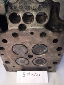 Cat 3516 cylinder head combustion face before and after ultrasonic cleaning — as received