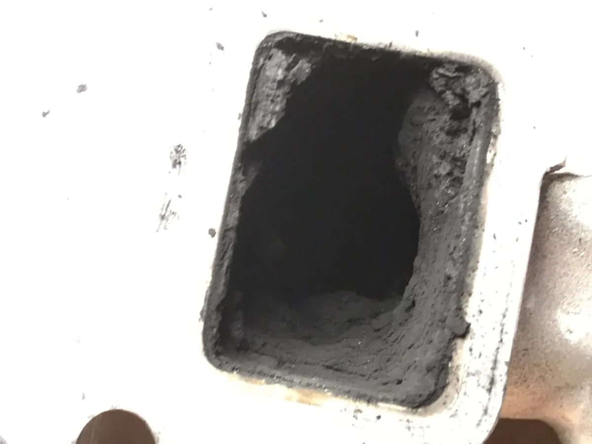 Inlet port carbonised solid, the casting invisible under it.