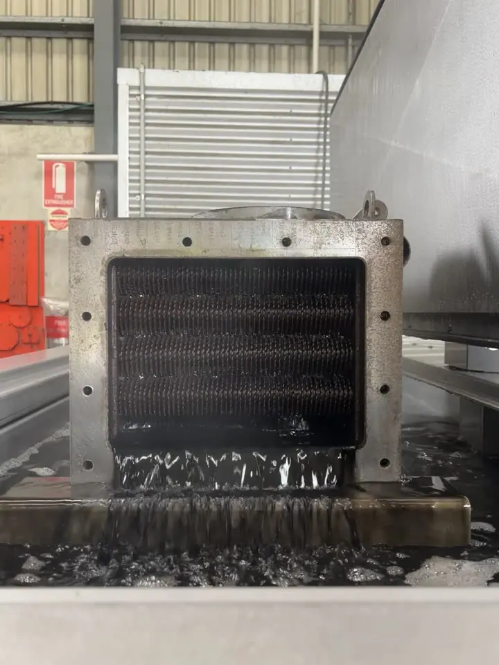 Fouled cooler core lifted out of an UltraTecno ultrasonic tank