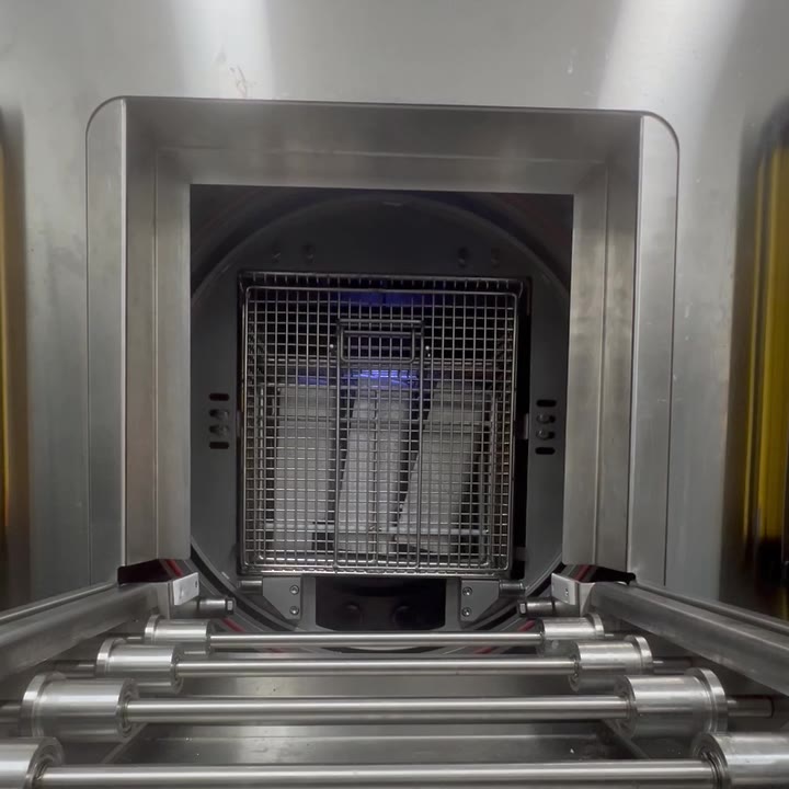 Clip: the door opens and the basket rolls out onto the conveyor